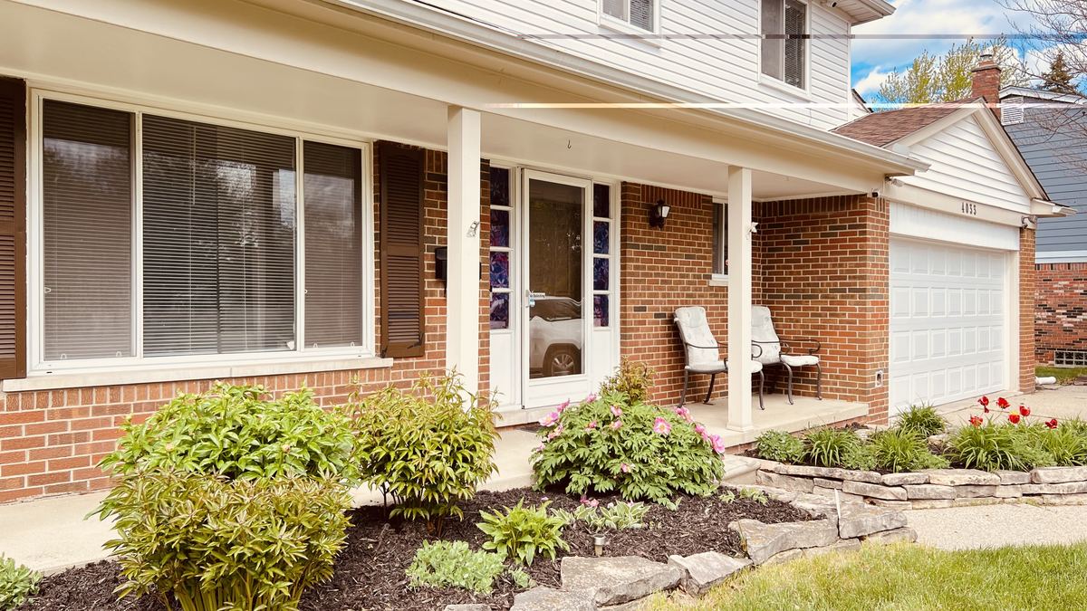 Front porch entry with stained glass sidelights and flowering landscaping
