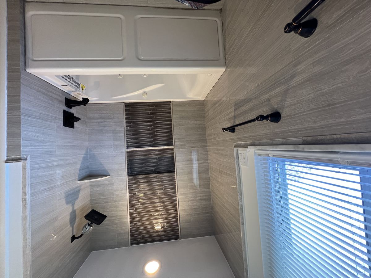 Main bathroom — full jacuzzi soaking tub with tile surround